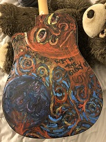 back of acoustic guitar with psychedelic painted artwork