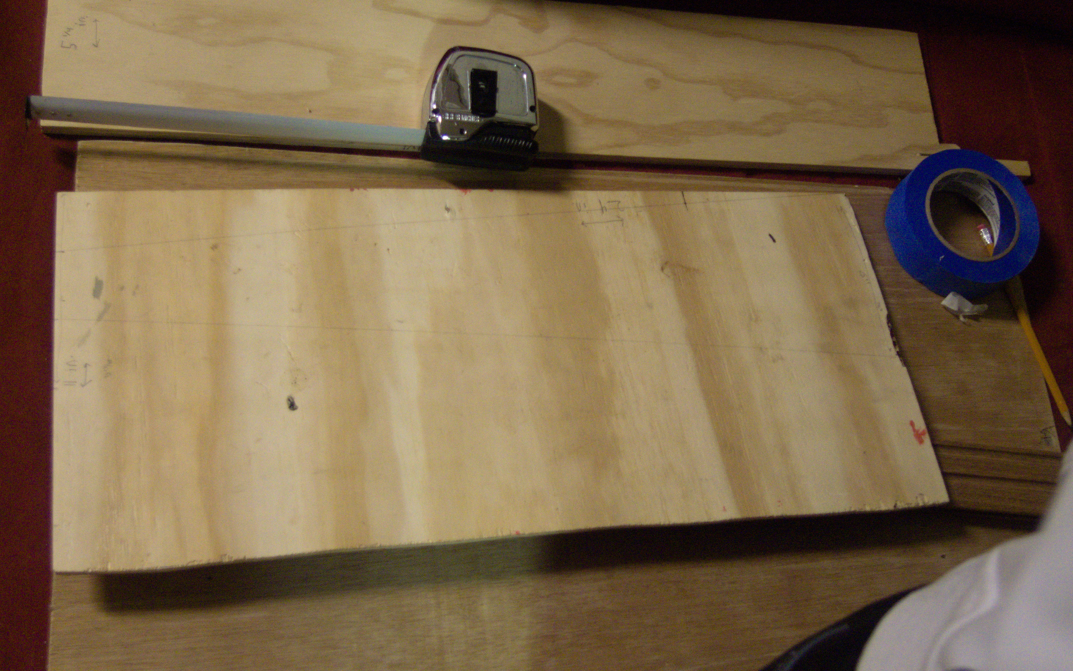 a plank of wood with a trapezoidal shape penciled in.