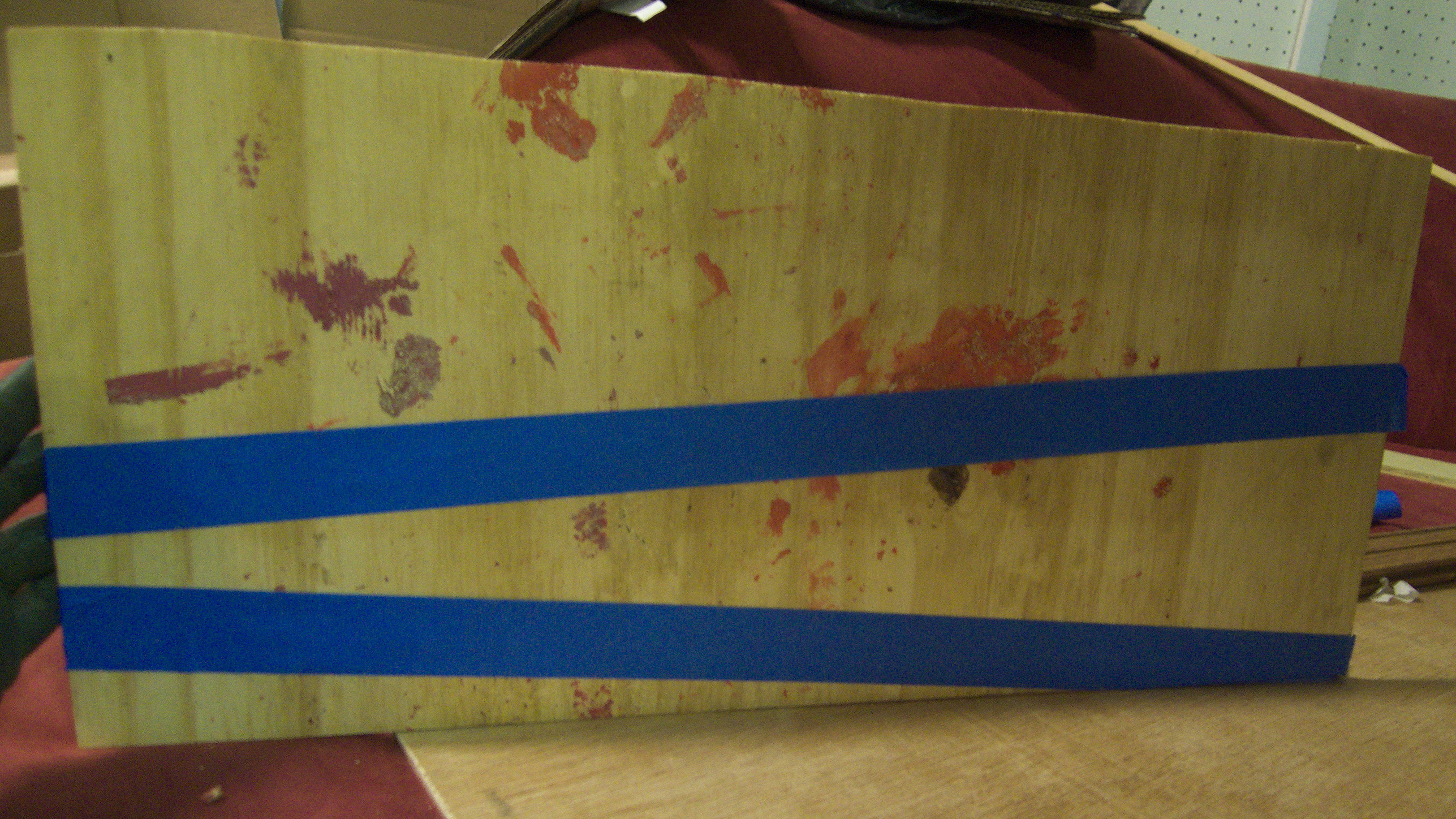 plank of wood with tape on it.