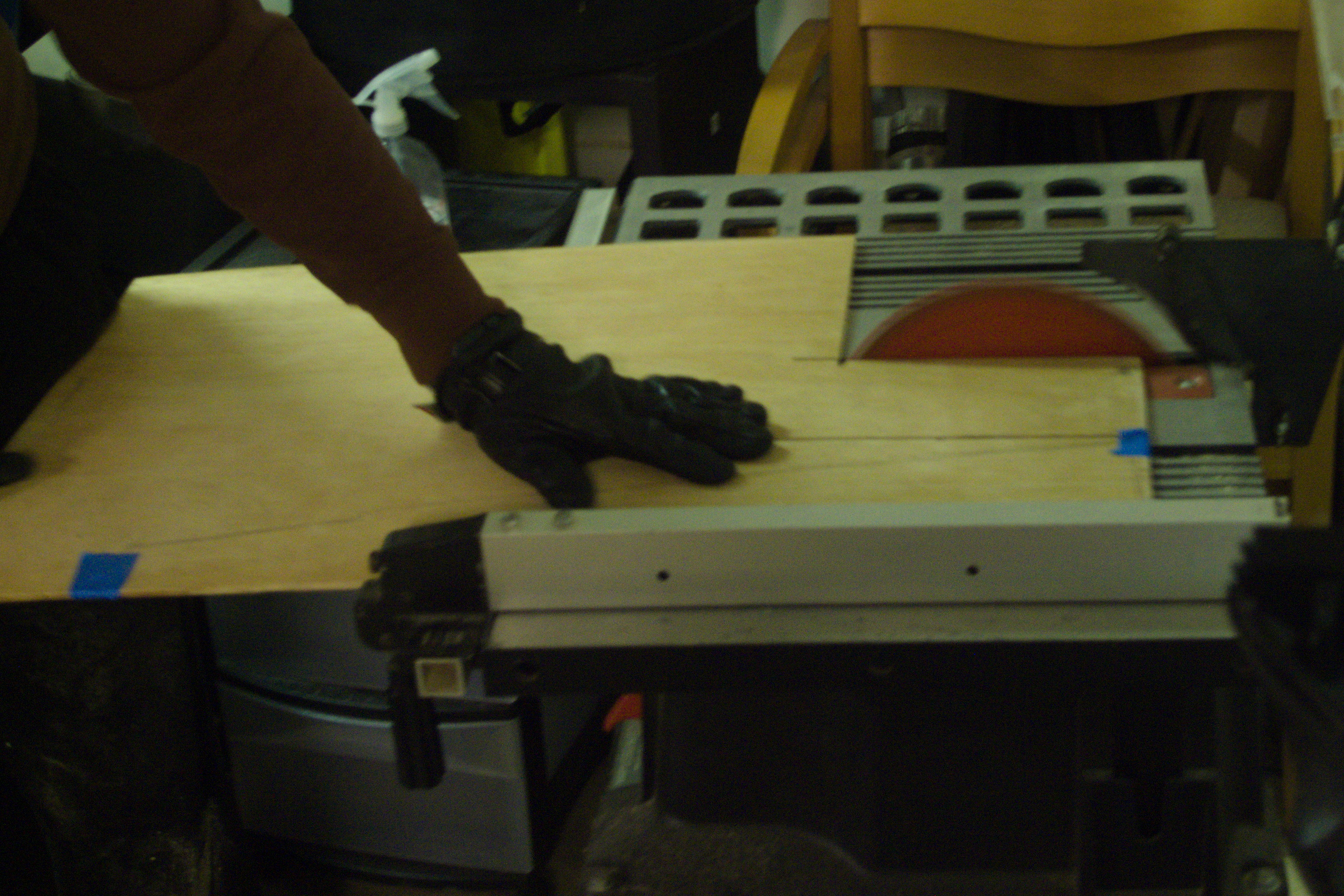 the wood being fed into a power saw.