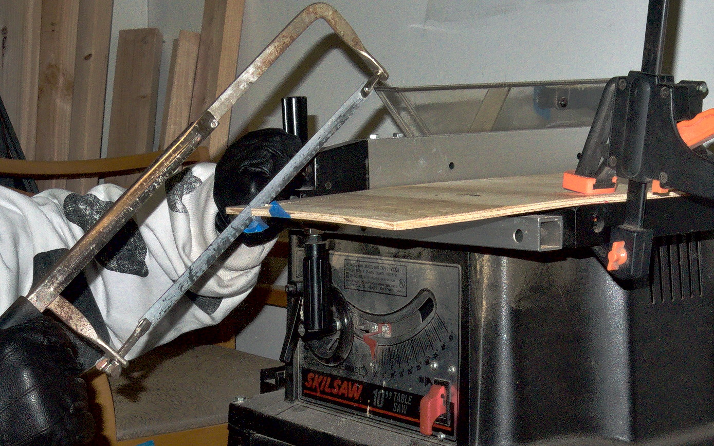 handsaw biting into wood.